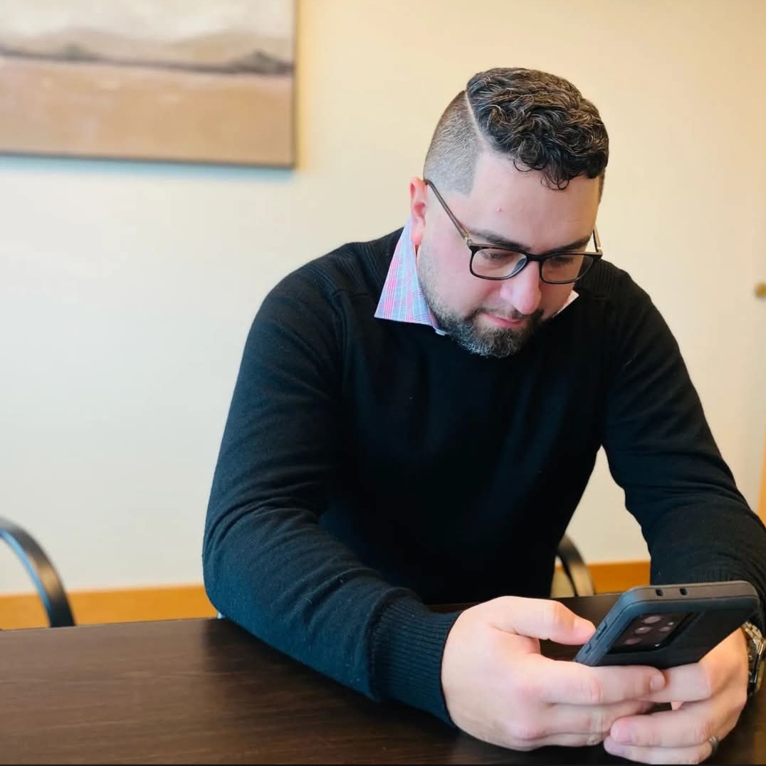 Dominic Kramer, mortgage loan originator at Rate, taking a client call at his desk