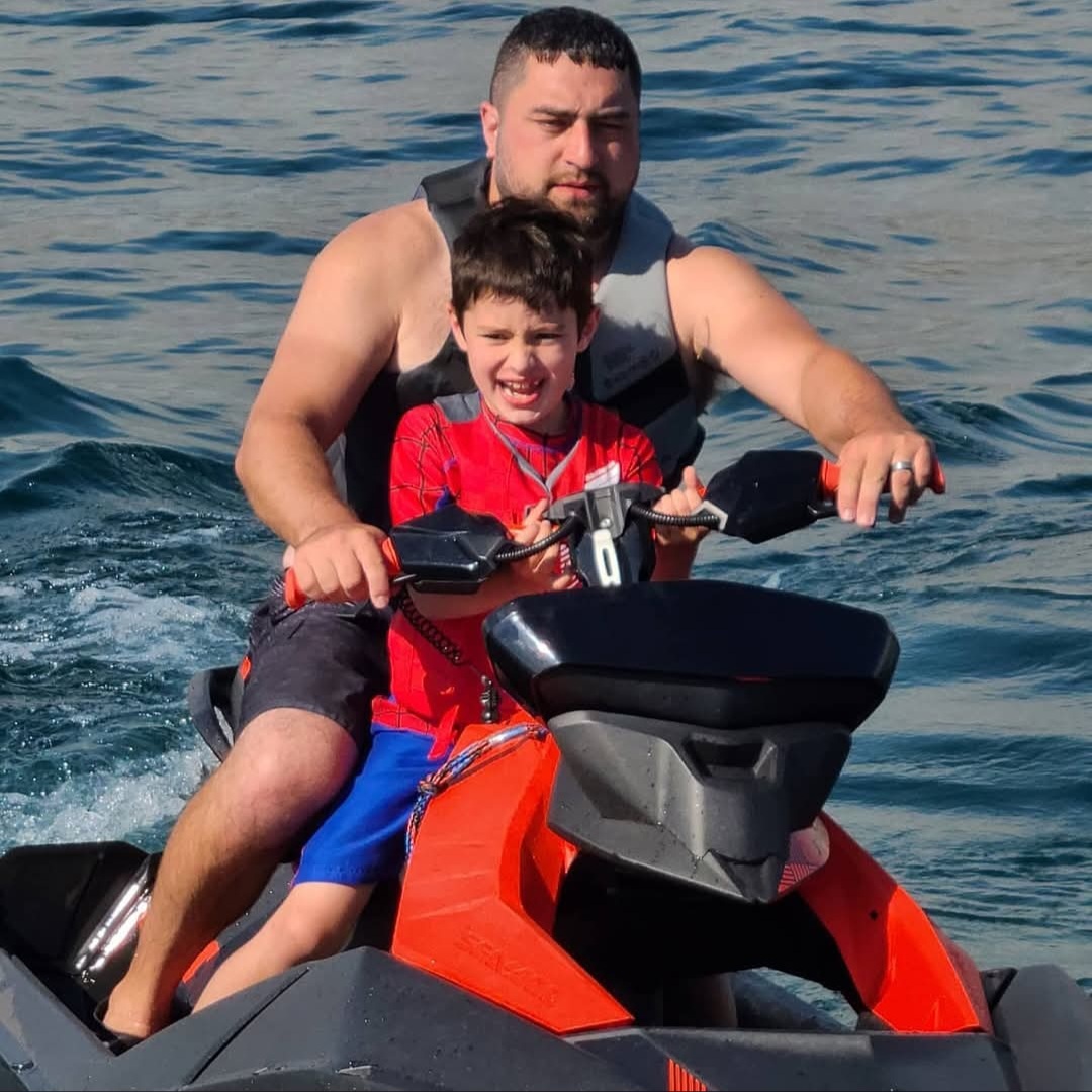 Dominic Kramer on the lake with his son